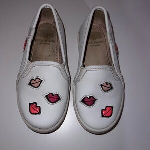 Kate Spade White Slip-On Shoes with Lip Design